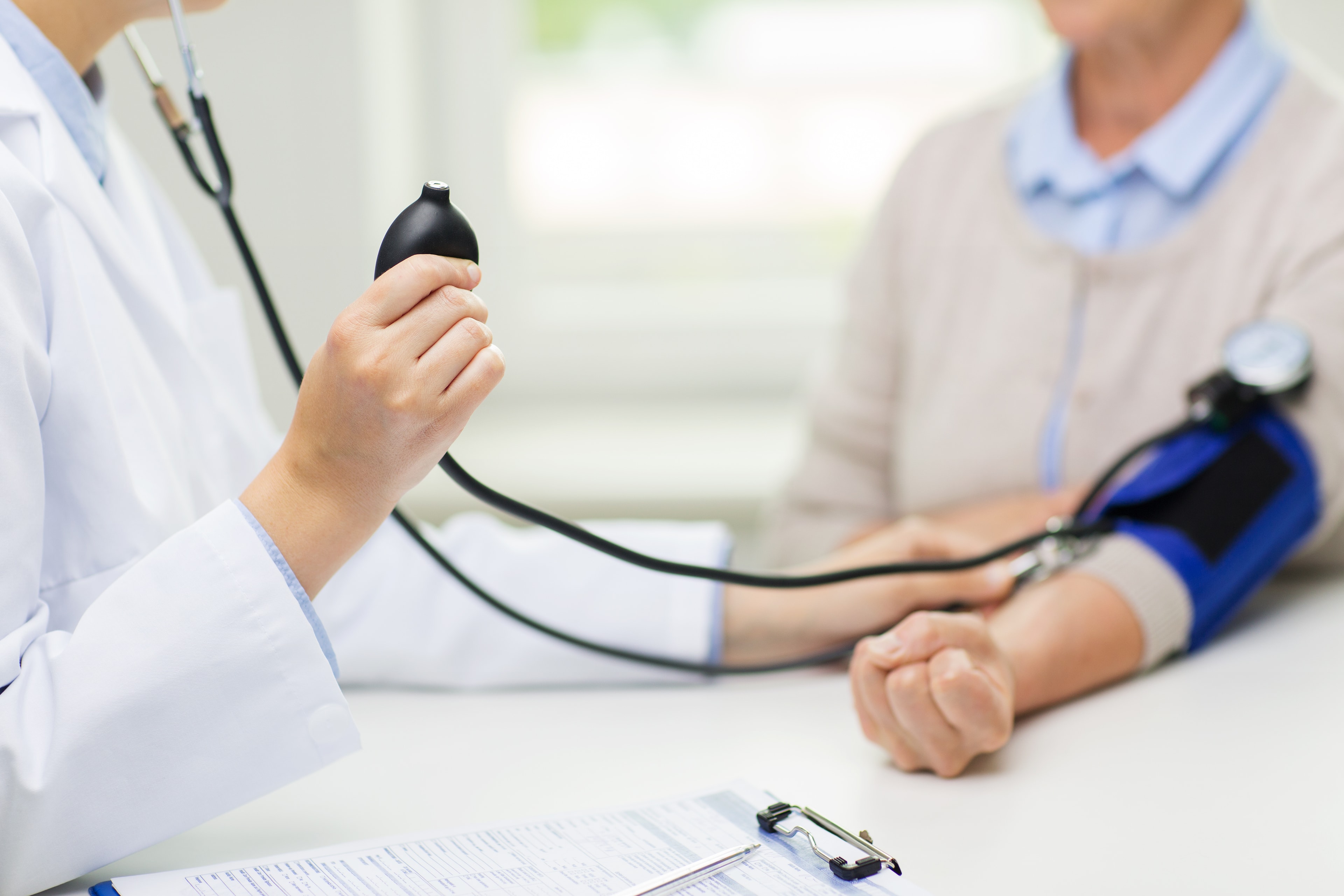Cash Care Health provider taking patient blood pressure
